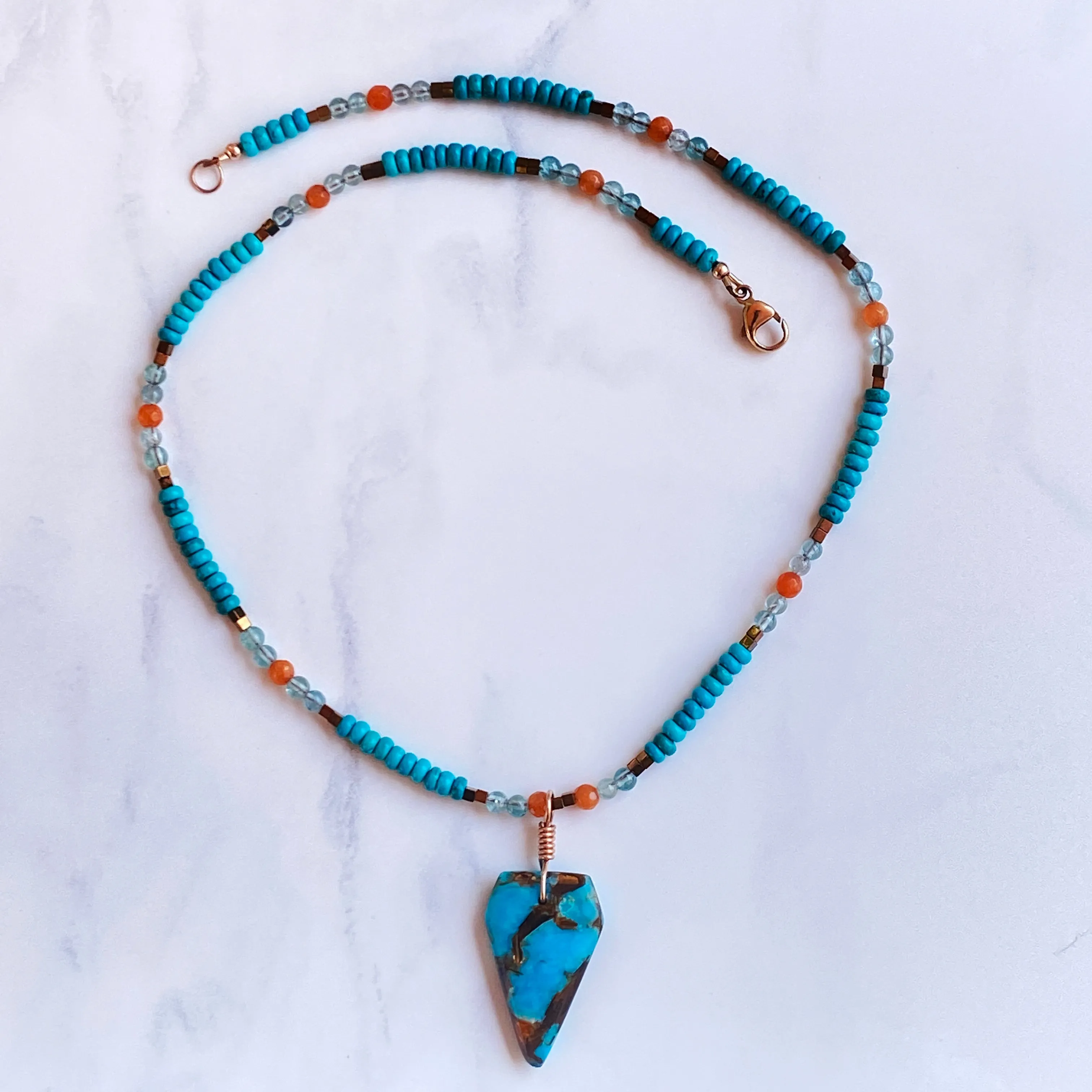 Bornite gemstone arrowhead pendant on Blue Howlite beaded necklace