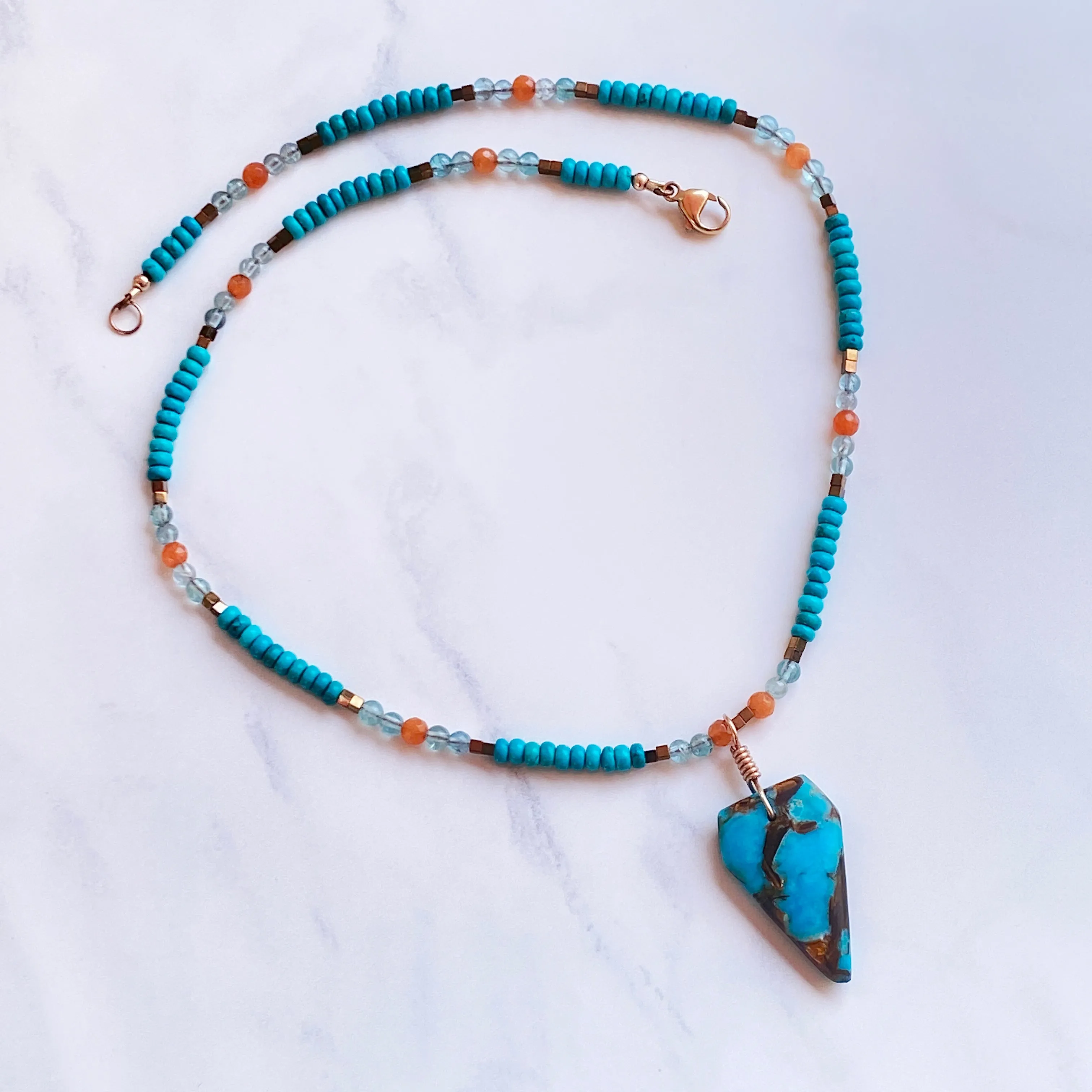 Bornite gemstone arrowhead pendant on Blue Howlite beaded necklace